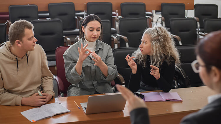 A group communicating in sign language at a meeting